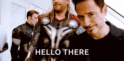 A Group Of Avengers Are Standing Next To Each Other And A Man Is Standing In The Middle Of The Group . GIF
