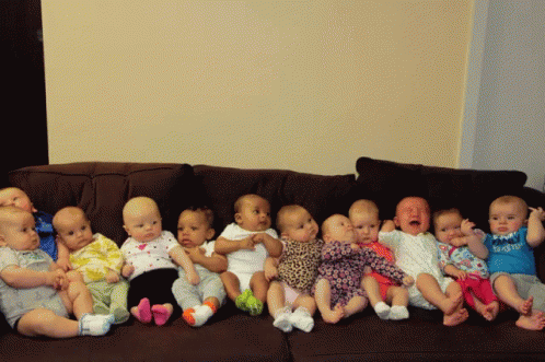 A Group Of Babies Are Sitting On A Couch And One Of Them Is Wearing A Shirt That Says Daddy GIF