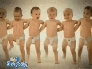 A Group Of Baby 'S In Diapers Are Dancing Together GIF