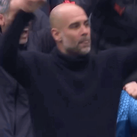 A Group Of Bald Men Are Sitting In A Stadium With Their Hands In The Air . GIF