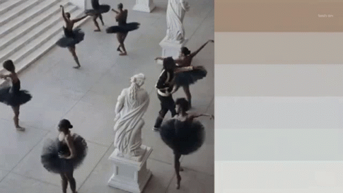 A Group Of Ballerinas Are Dancing In Front Of A Statue Of A Woman GIF