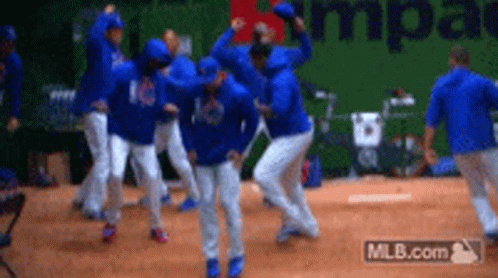A Group Of Baseball Players Are Celebrating On The Field GIF