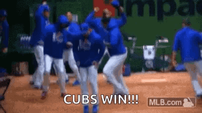 A Group Of Baseball Players Are Dancing On A Baseball Field . GIF