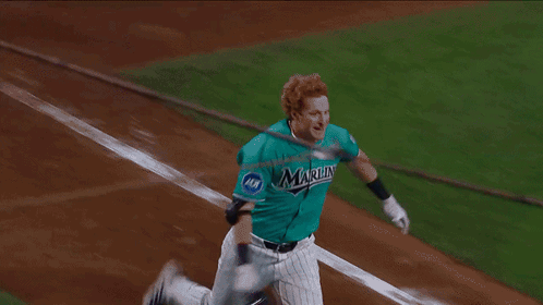 A Group Of Baseball Players Are Huddled Together And One Of Them Has The Number 21 On His Back GIF