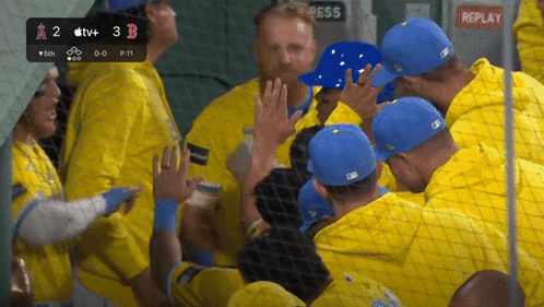 a group of baseball players are huddled together in a dugout with replay written on the bottom