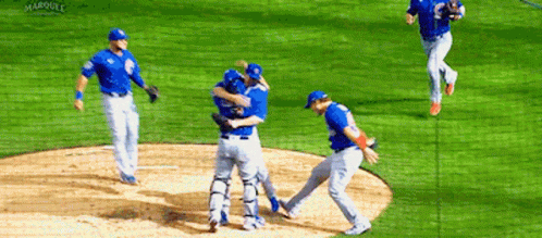 A Group Of Baseball Players Are Hugging Each Other On A Field That Says Marquee On The Bottom GIF