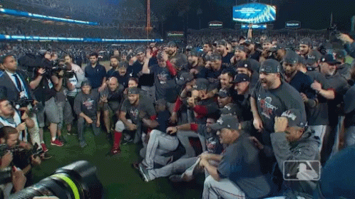 A Group Of Baseball Players Are Posing For A Photo With A Budweiser Sign In The Background GIF