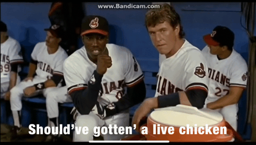 A Group Of Baseball Players Are Sitting In A Dugout With The Words Should Ve Gotten A Live Chicken GIF