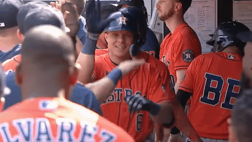 A Group Of Baseball Players Are Standing In A Dugout And One Of Them Is Wearing A Jersey That Says Be On It GIF