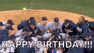 A Group Of Baseball Players Are Standing In A Huddle On A Baseball Field And Celebrating . GIF
