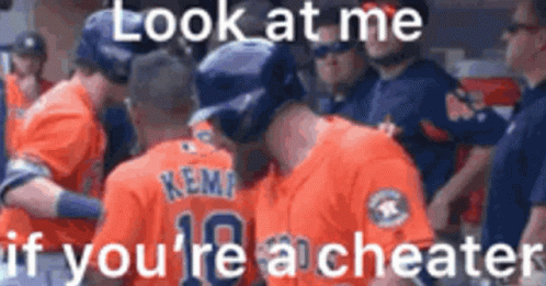 A Group Of Baseball Players Are Standing Next To Each Other In A Dugout And Talking To Each Other . GIF