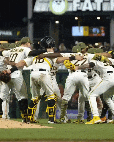 A Group Of Baseball Players Huddle Together With One Wearing The Number 30 GIF