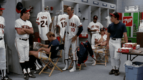 A Group Of Baseball Players In A Locker Room With A 7Up Vending Machine GIF