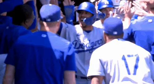 A Group Of Baseball Players Wearing Blue Jerseys With The Word Dragons On Them GIF