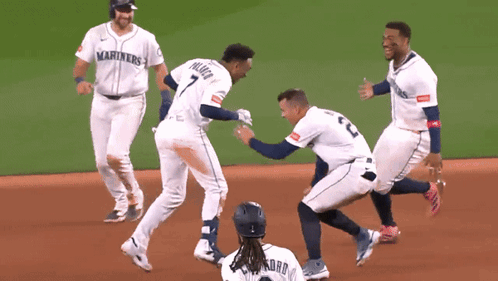 A Group Of Baseball Players Wearing Mariners Jerseys Are On The Field GIF