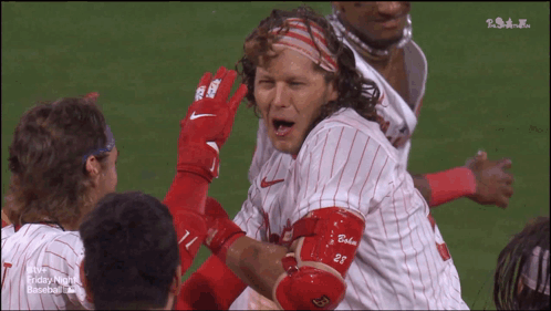 A Group Of Baseball Players With One Wearing A Jersey With The Number 28 On It GIF