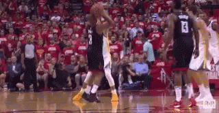 A Group Of Basketball Players Are Playing A Game Of Basketball In Front Of A Crowd . GIF