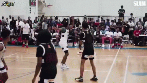 A Group Of Basketball Players Are Playing A Game Of Basketball On A Court . GIF