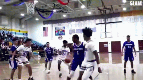 A Group Of Basketball Players Are Playing A Game Of Basketball On A Court . GIF