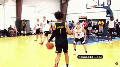 A Group Of Basketball Players Are Playing A Game Of Basketball On A Court . GIF