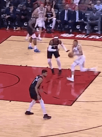 A Group Of Basketball Players Are Playing A Game On A Basketball Court . GIF
