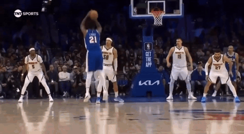 A Group Of Basketball Players Are Playing A Game On A Court . GIF