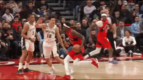 A Group Of Basketball Players Are Playing A Game On A Court . GIF