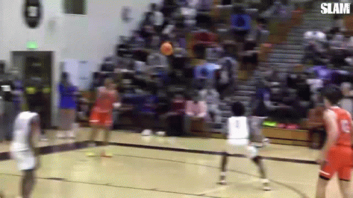 A Group Of Basketball Players Are Playing Basketball On A Court . GIF