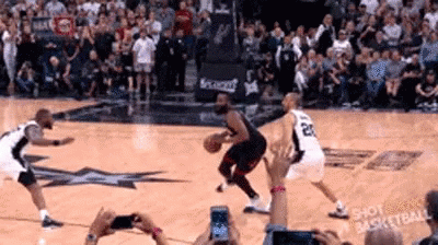 A Group Of Basketball Players Are Playing Basketball On A Court . GIF
