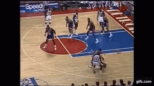 A Group Of Basketball Players Are Playing Basketball On A Court . GIF