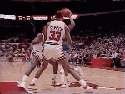 A Group Of Basketball Players Are Playing Basketball On A Court . One Of The Players Is Wearing A Number 33 Jersey . GIF