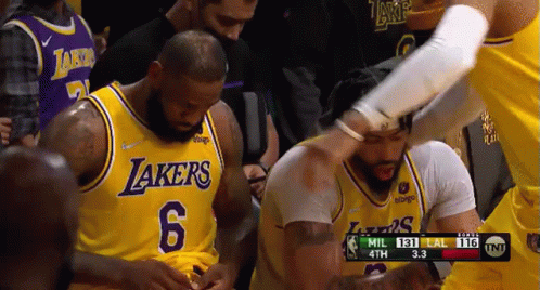 A Group Of Basketball Players Are Standing Next To Each Other In A Basketball Game . GIF