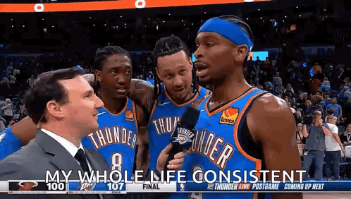 A Group Of Basketball Players Are Standing Next To Each Other On A Court . GIF