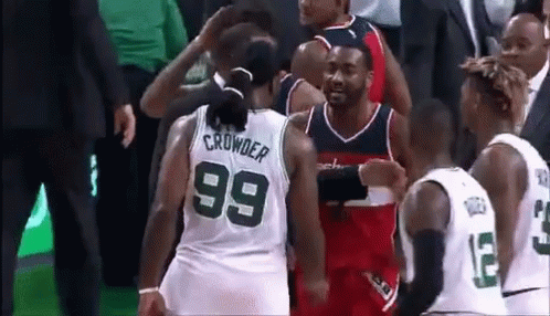 A Group Of Basketball Players Are Standing Next To Each Other On A Court . GIF