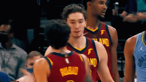 A Group Of Basketball Players Are Standing On A Court . GIF