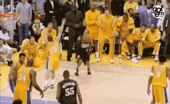 A Group Of Basketball Players Are Standing On A Court . GIF