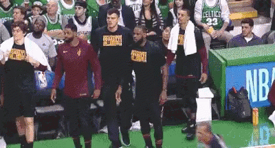 A Group Of Basketball Players Standing In Front Of A Crowd At A Basketball Game . GIF