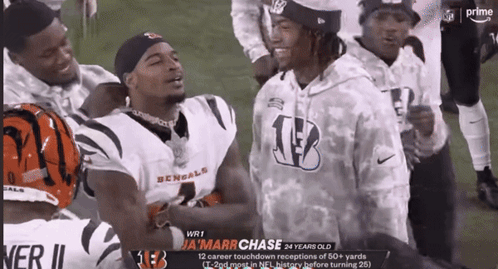 a group of bengals football players are standing on a field