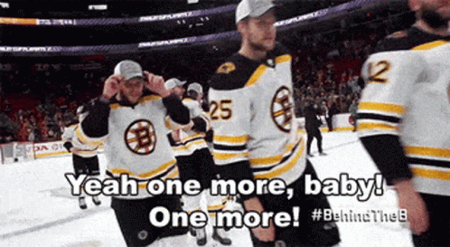 A Group Of Boston Bruins Hockey Players Are Standing On The Ice GIF