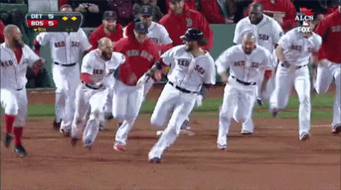 A Group Of Boston Red Sox Players Are Running On The Field GIF