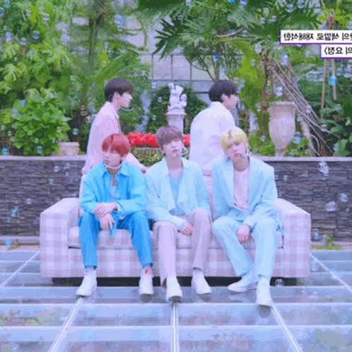 A Group Of Boys Are Sitting On A Couch With Bubbles Surrounding Them GIF