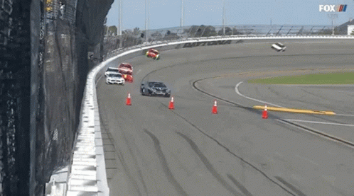A Group Of Cars Are Racing On A Race Track With A Fox Logo In The Background GIF