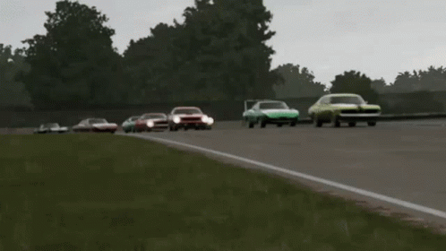 A Group Of Cars Are Racing On A Track And One Of Them Has The Word Ford On It GIF