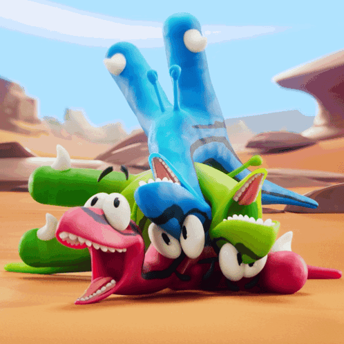 A Group Of Cartoon Characters Are Laying On Top Of Each Other In A Desert GIF