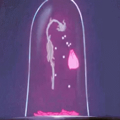 A Group Of Cartoon Characters Are Standing Around A Table With A Statue On Top Of It GIF