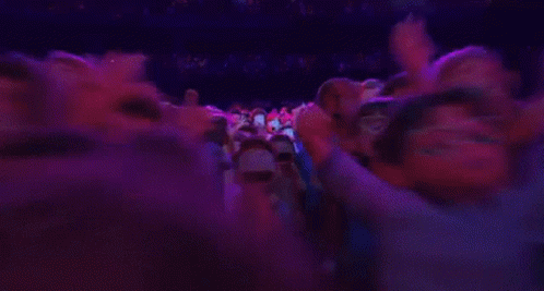 A Group Of Cartoon Characters Are Standing In A Room With Purple Lights . GIF