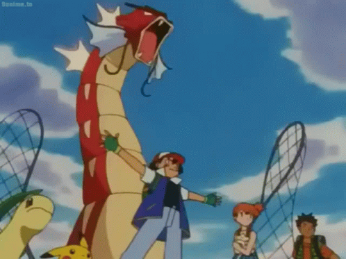 A Group Of Cartoon Characters Are Standing In Front Of A Large Red And Yellow Dragon . GIF