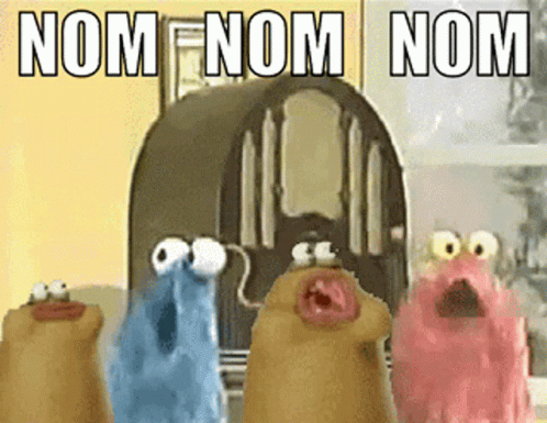 A Group Of Cartoon Characters Are Standing In Front Of A Radio With The Words Nom Nom Nom Written On It GIF