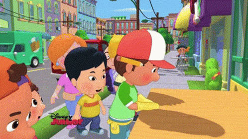 A Group Of Cartoon Characters Are Walking Down A Street With Disney Junior Written On The Bottom Right GIF