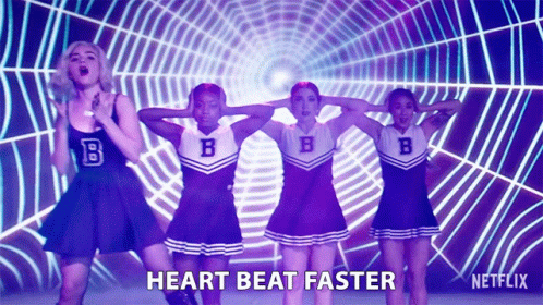 A Group Of Cheerleaders Are Dancing In Front Of A Spider Web And The Words Heart Beat Faster Are On The Screen GIF